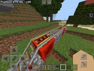 A railway with powered rails being powered with redstone blocks (Image via u/the_Smurf58skii on Reddit)
